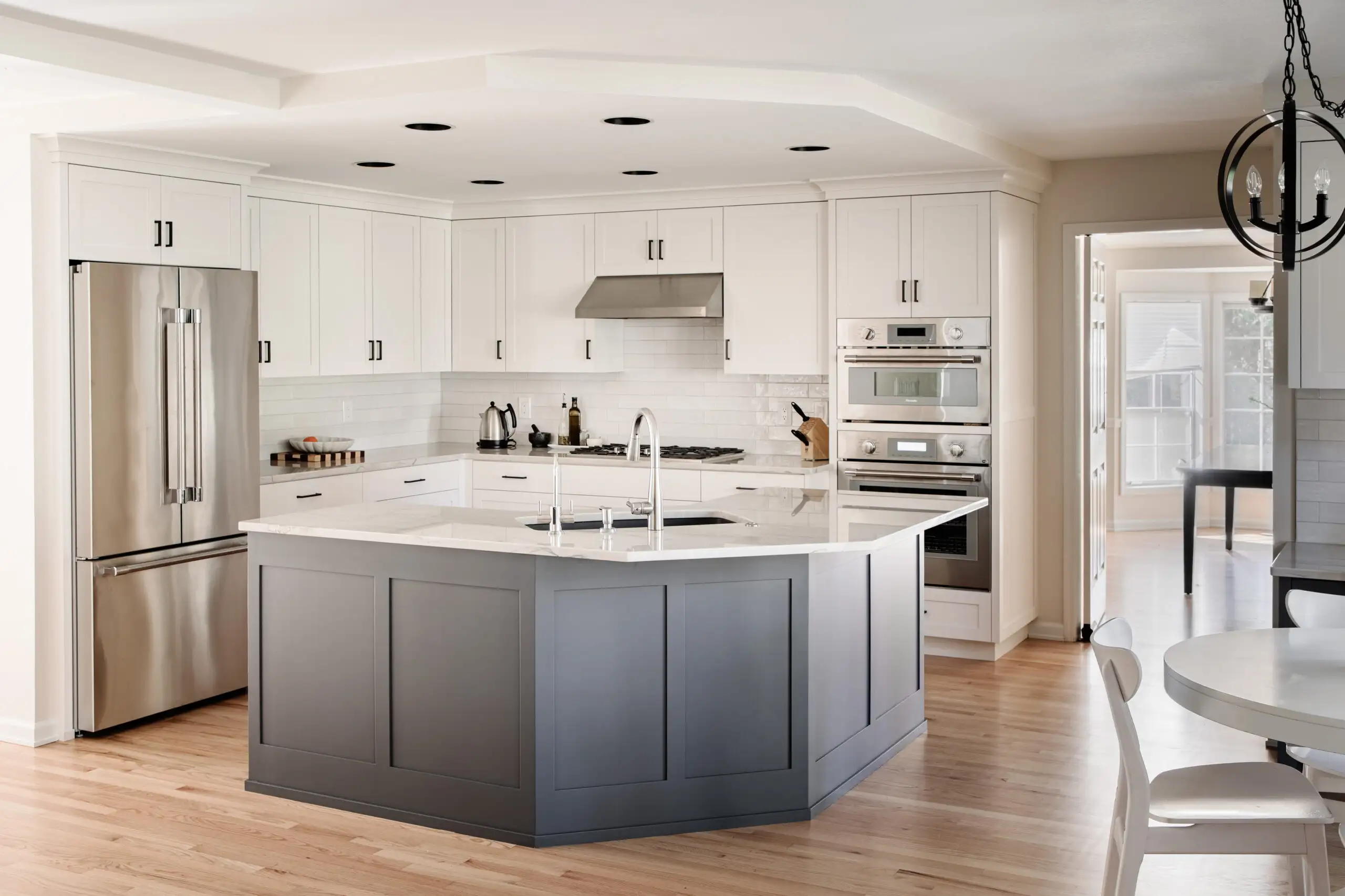 Reimagined kitchen with white shaker cabinets and a large quartz island built by Black Cat Design Build LLC in Clark County, WA.