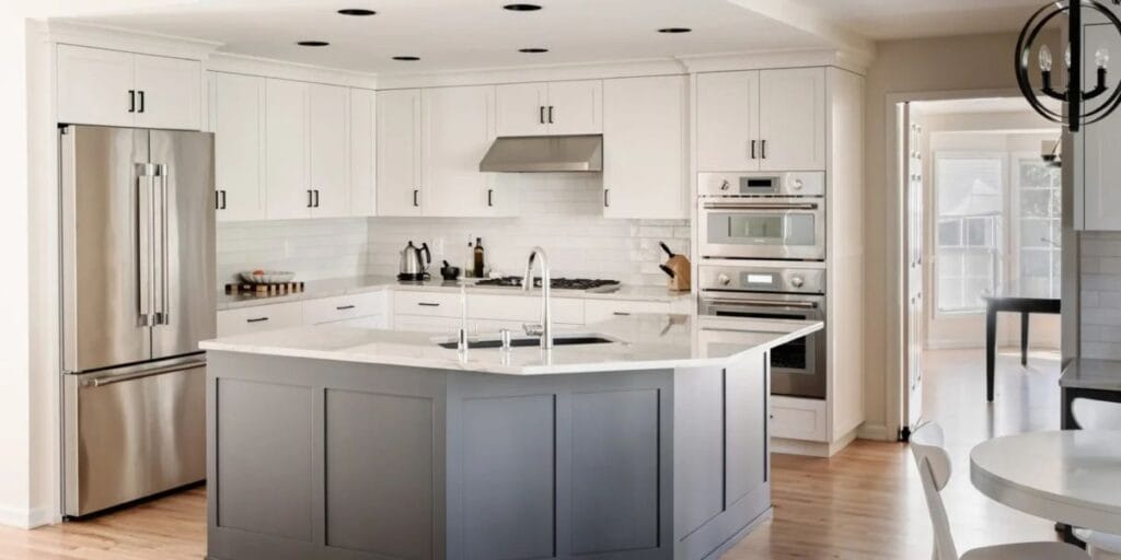 Homeowners reviewing kitchen remodel plans, layouts, and material samples with a design-build contractor before construction | What Homeowners Should Know Before Starting a Kitchen Remodel